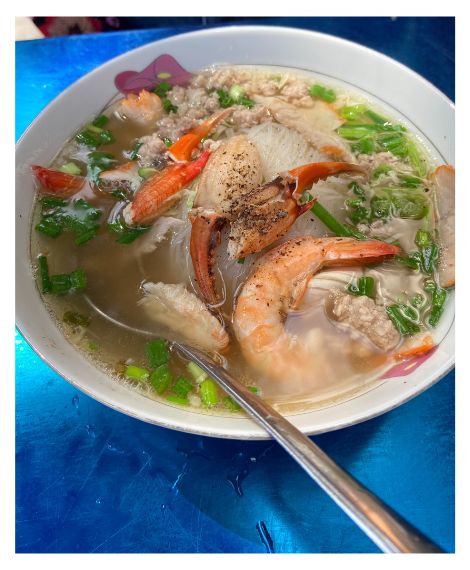 Colourful photo of a delicious bowl of Vietnamese seafood pho.