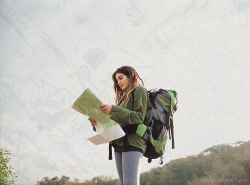 A digital illustration of a lost traveller, using graphic elements, textures, and a stock image of a female backpacker. “Hiker Looking at the Way” by Odua Images/Canva.